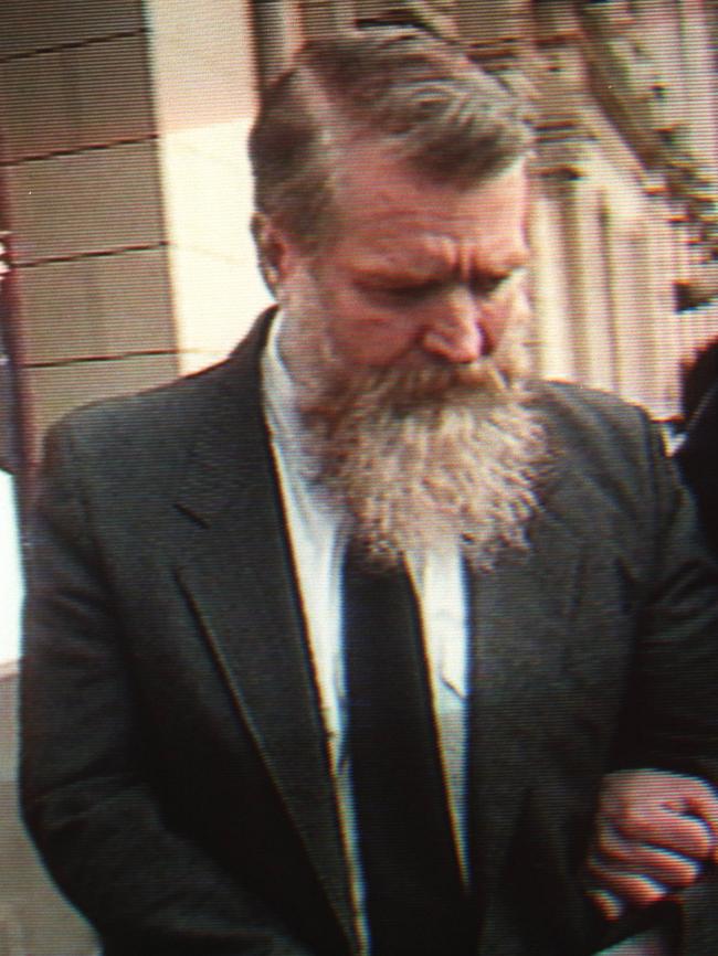 Raymond Edmonds, aka, Mr Stinky, being led from court. Picture: Channel 9