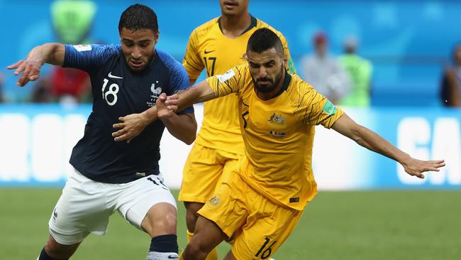 Aziz Behich tangles with Nabil Fekir.