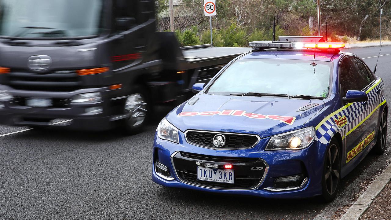 Victoria Police taking industrial action in wage dispute. A police car has its lights flashing warning cars along Yarra Blvd Richmond of a speed camera along the road. Picture: Ian Currie