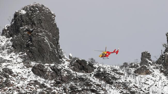 The Westpac rescue helicopter rescues an injured snowboarder at the top of The Needles West of Maydena. Picture: Zak Simmonds