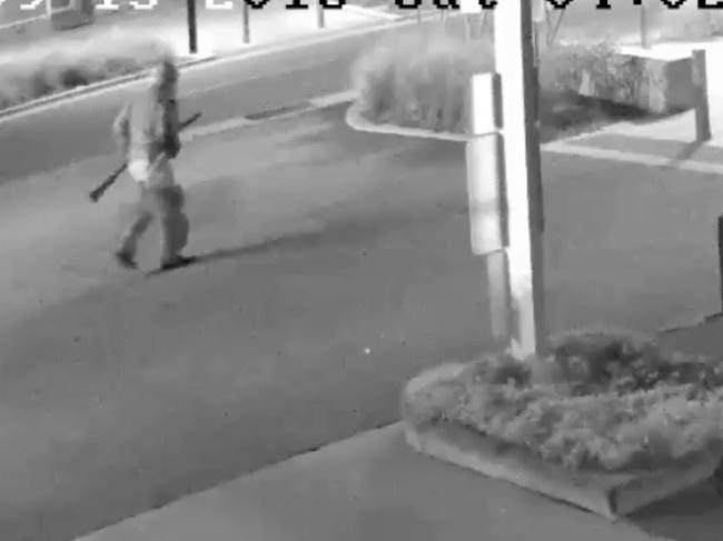 Warner armed with his rifle captured on CCTV on Crawford St near intersection of Monaro St.