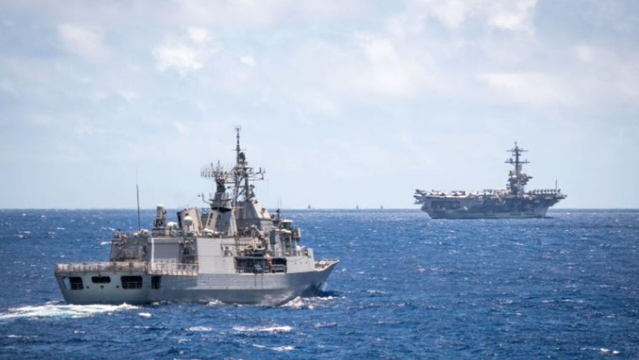 An Australian ANZAC class frigate accompanies a US nuclear-powered aircraft carrier. The usefulness of these enormous ships is being questioned in an era of fast, long-range missile swarms. Picture: ADF