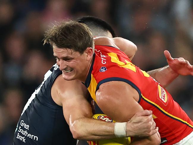 MELBOURNE, AUSTRALIA - APRIL 13: Matt Crouch of the Crows is tackled by Matthew Kennedy of the Blues during the round five AFL match between Carlton Blues and Adelaide Crows at Marvel Stadium, on April 13, 2024, in Melbourne, Australia. (Photo by Quinn Rooney/Getty Images)