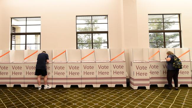 Voters fill in their ballots at Brisbane City Hall in Brisbane on Saturday.