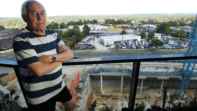 Karl Bresky on his balcony overlooking the construction. Picture: Hamish Blair