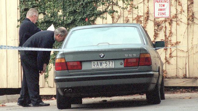 Police examine Mladenich’s car the Esquire Motel.