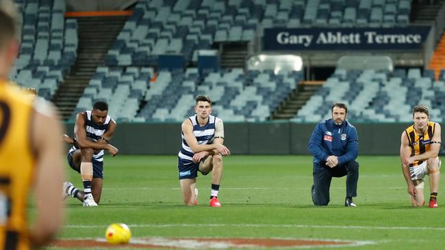 Players and coaches take a knee in support of the Black Lives Matter movement. Picture: Michael Willson/AFL