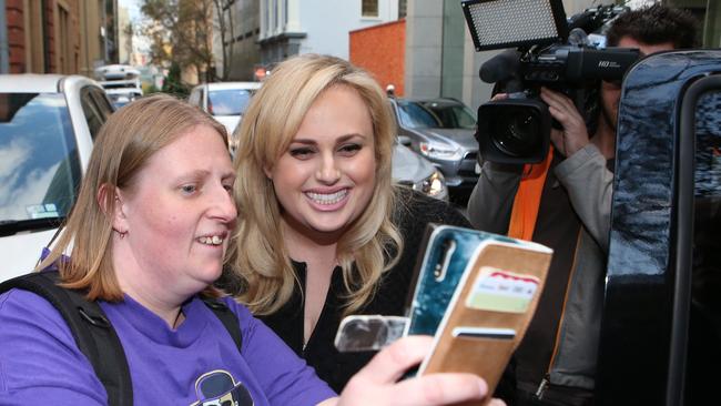 Rebel Wilson poses for a selfie with a fan outside the Supreme Court. Picture: AAP