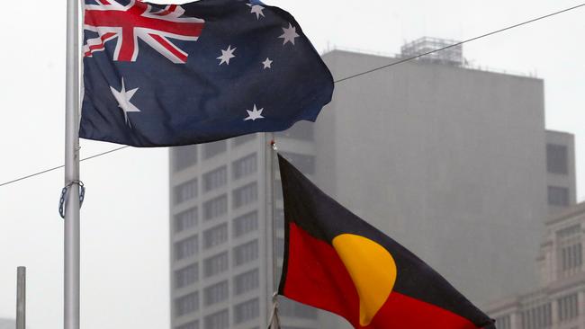 MELBOURNE, AUSTRALIA - NewsWire Photos, JULY 27, 2022. The Melbourne City Council voted in favour of a motion brought by Lord Mayor Sally Capp on Tuesday night, with City of Melbourne management now set to review how January 26 is celebrated.  The Torres Strait flag, Australian flag and Aboriginal flag fly in Federation Square. Picture: NCA NewsWire / David Crosling