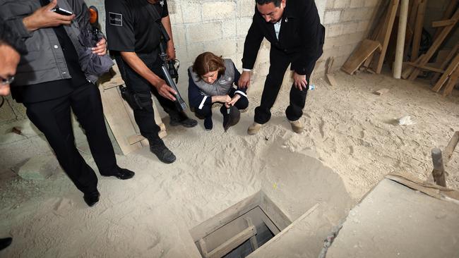 Mexican officials inspect the alleged end of the tunnel through which Guzman could have escaped from the Altiplano prison. Picture: AFP