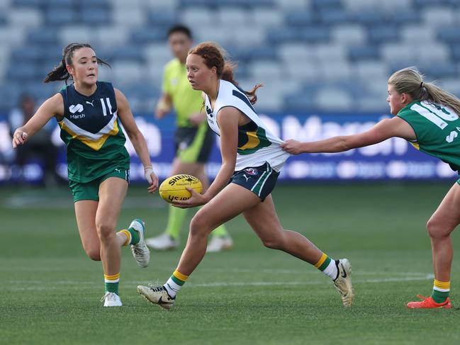 Evie Cowcher gives two opponents the slip. Picture: Daniel Pockett/AFL Photos/via Getty Images