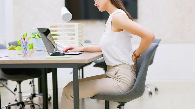 pain at work - asian business woman suffer from spine and waist ache in office