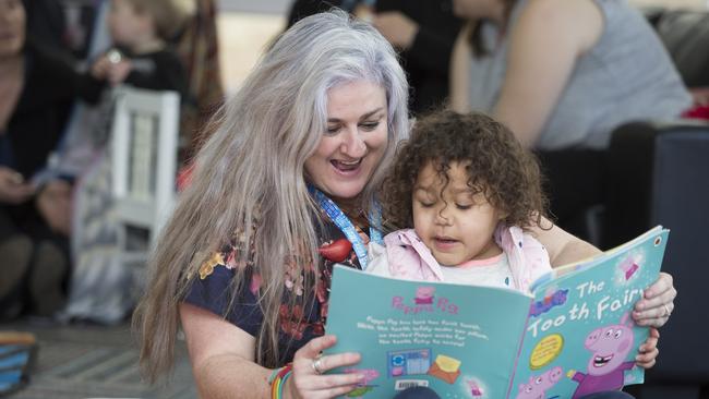 Shannon Jimeno from Banyule Council reads a book to Ngartair. Picture: Rodney Dekker