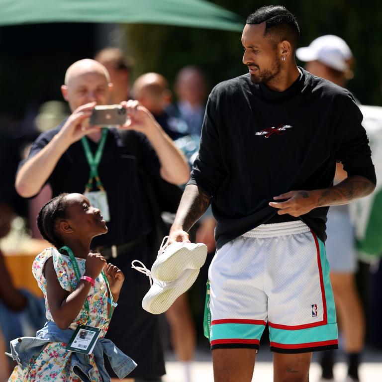 Nick Kyrgios posted this picture of him chatting with a young fan after the charge came to light (Photo by Ryan Pierse/Getty Images)