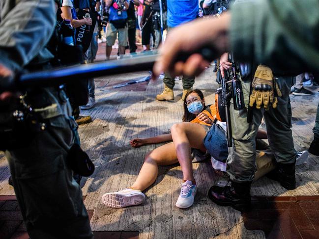 TOPSHOT - People are detained as pro-democracy protesters gather in the Causeway Bay district of Hong Kong on June 12, 2020. - Thousands of Hong Kongers sang a protest anthem and chanted slogans across the city on June 12 as they marked the one-year anniversary of major clashes between police and pro-democracy demonstrators. (Photo by Anthony WALLACE / AFP)