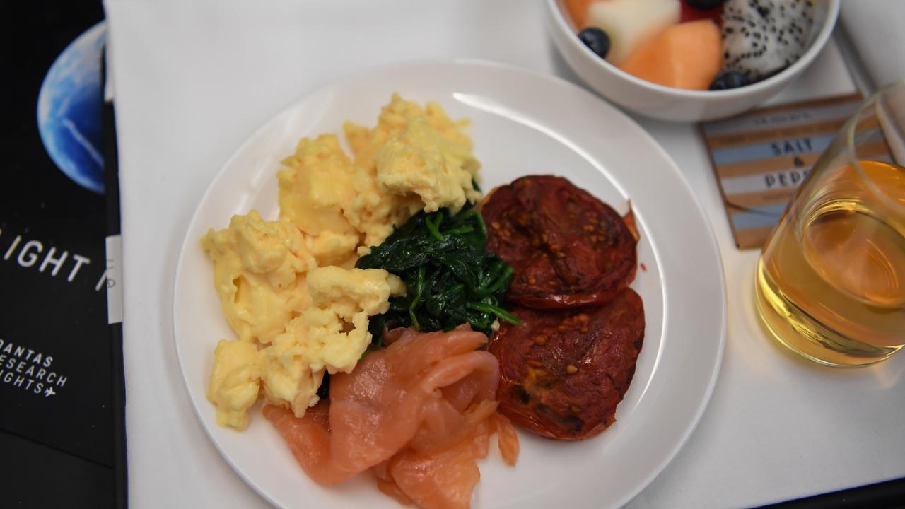 Breakfast was scrambled eggs, roasted tomatoes, spinach and smoked salmon – along with a juice or kombucha. Picture: James Morgan/Qantas via AP