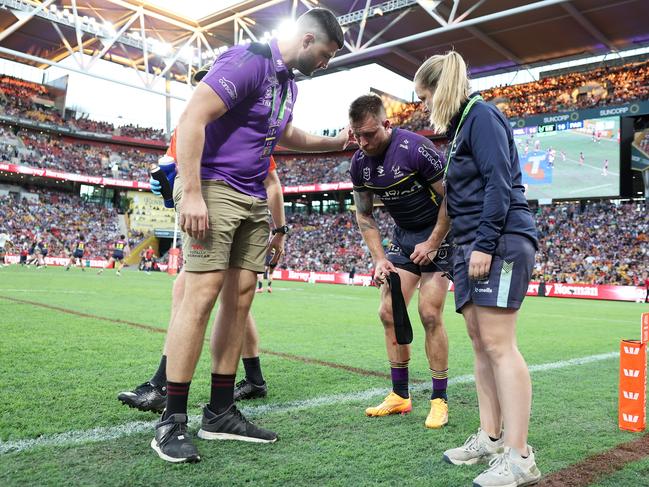 Cameron Munster limps from the field. Picture: Hannah Peters/Getty Images