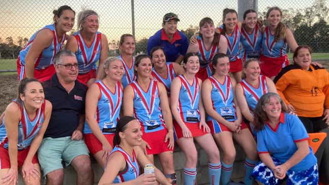 The Wanderers A1 women and coaching staff celebrate their grand final win.