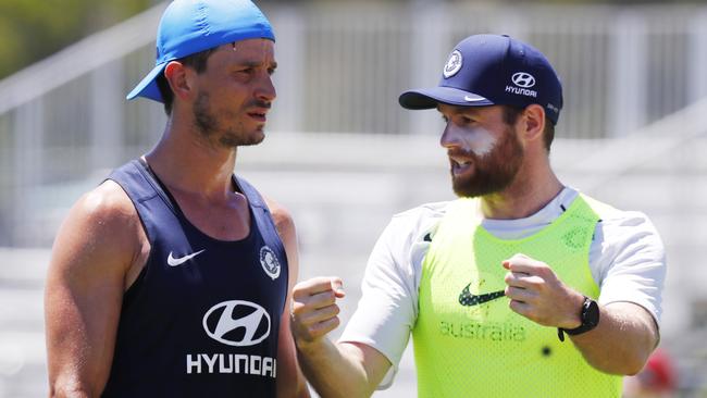 Docherty gives teammate Alex Silvagni some tips at training. Pic: Michael Klein