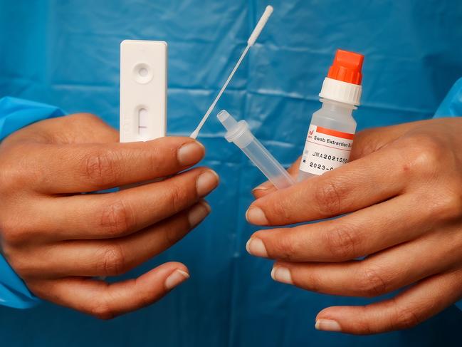 Registered Nurse On Hongsopha  of Suretest in Melbourne with a Rapid Antigen Test kit. Picture: Ian Currie