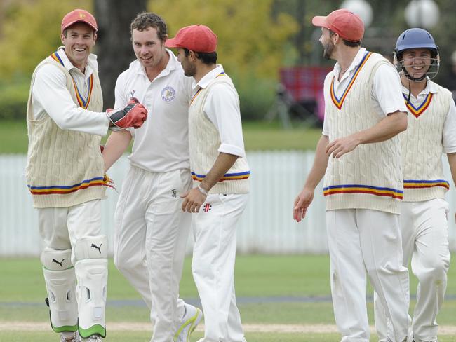 Frankston Peninsula players celebrate after Jon Holland (centre) claimed the wicket of Darren Dempsey.