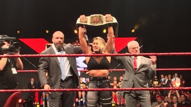 Rhea Ripley with Triple H and Johnny Saint.