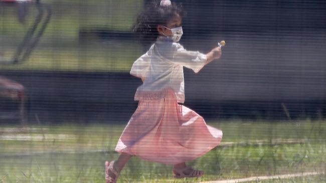 An evacuee girl plays outdoors on Christmas Island on Friday. Picture: Colin Murty