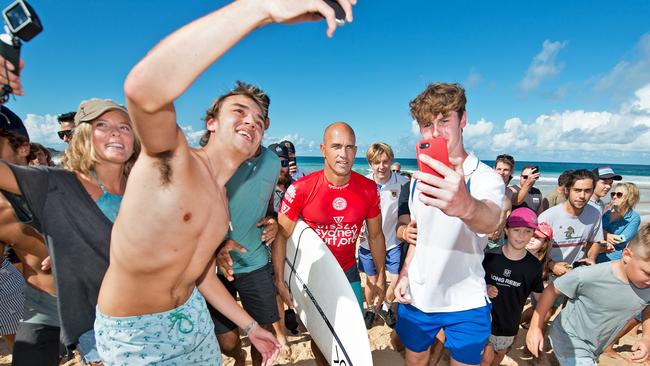 Kelly Slater mobbed by fans after he was eliminated in the third round of the Sydney Surf Pro at Manly last year. Pic: Troy Snook.