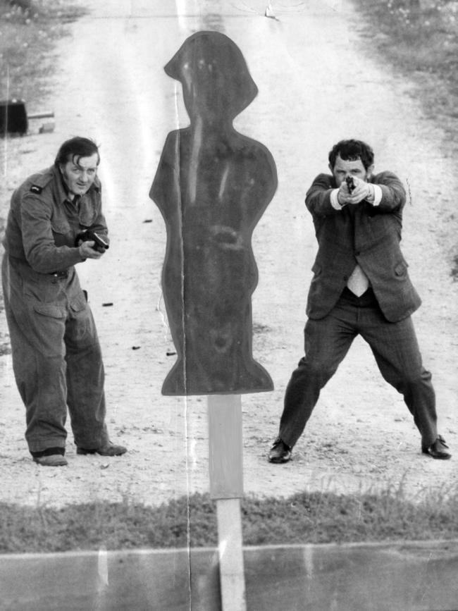 1975: South Australian police line up a target at the Dean Rifle Range. Detective Senior Constable Len Oliver, left, uses a 12-gauge riot shotgun and Detective Senior Constable I.W. Grose, of Hindmarsh CIB, has a .38 special revolver. File picture