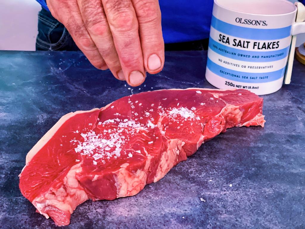 John Mauger salts some steak. Picture: Jenifer Jagielski