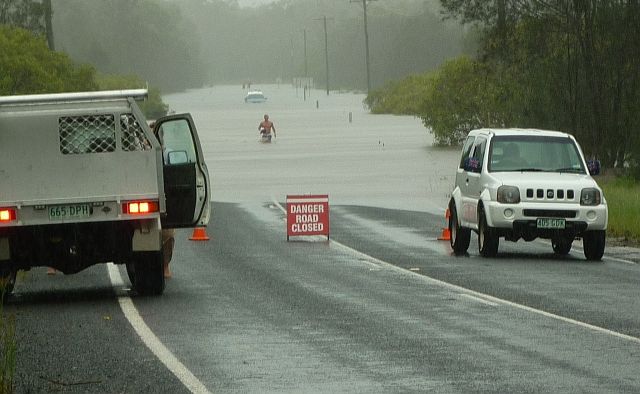 Sun 27 Jan. Pialba Burrum Heads Rd, driver wading out from his submerged car - User Contributed