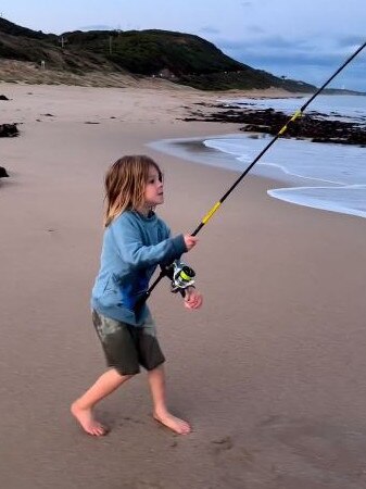 George Dangerfield reels in a fish from the shore. Picture: Instagram