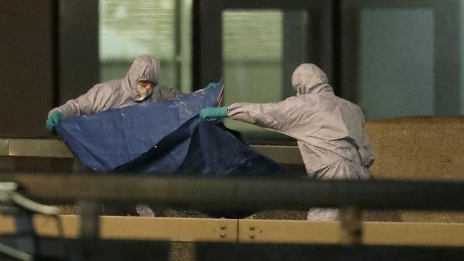 Police forensic officers work where a man was killed on London Bridge.