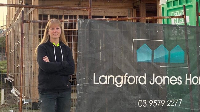 Donna Taylor with her unfinished Phillip Island home that Langford Jones Homes was building.