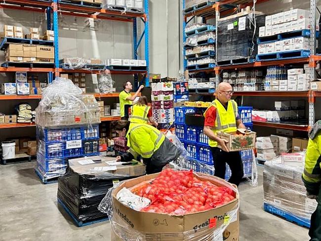 CEQ workers prepare to send stock from its Cairns warehouse to the ABIS supermarket in Kowanyama.