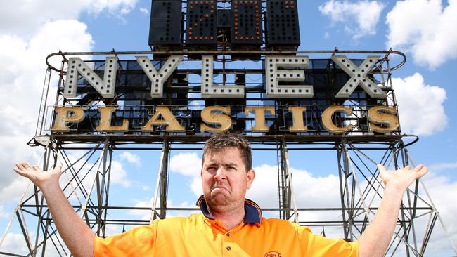 The iconic Nylex clock in Cremorne was turned on last night after being switched off since 2009. Sign installer Mark Griffiths with the sign. Picture: Brendan Francis