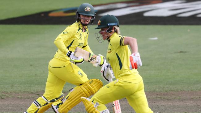 Australia's Rachael Haynes (L) and Beth Mooney in action against England. (Photo by MICHAEL BRADLEY / AFP)