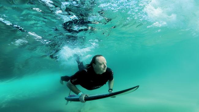 Ballina shark attack victim Jabez Reitman returns to the water at Broken Head near Byron Bay. Picture: Luke Marsden