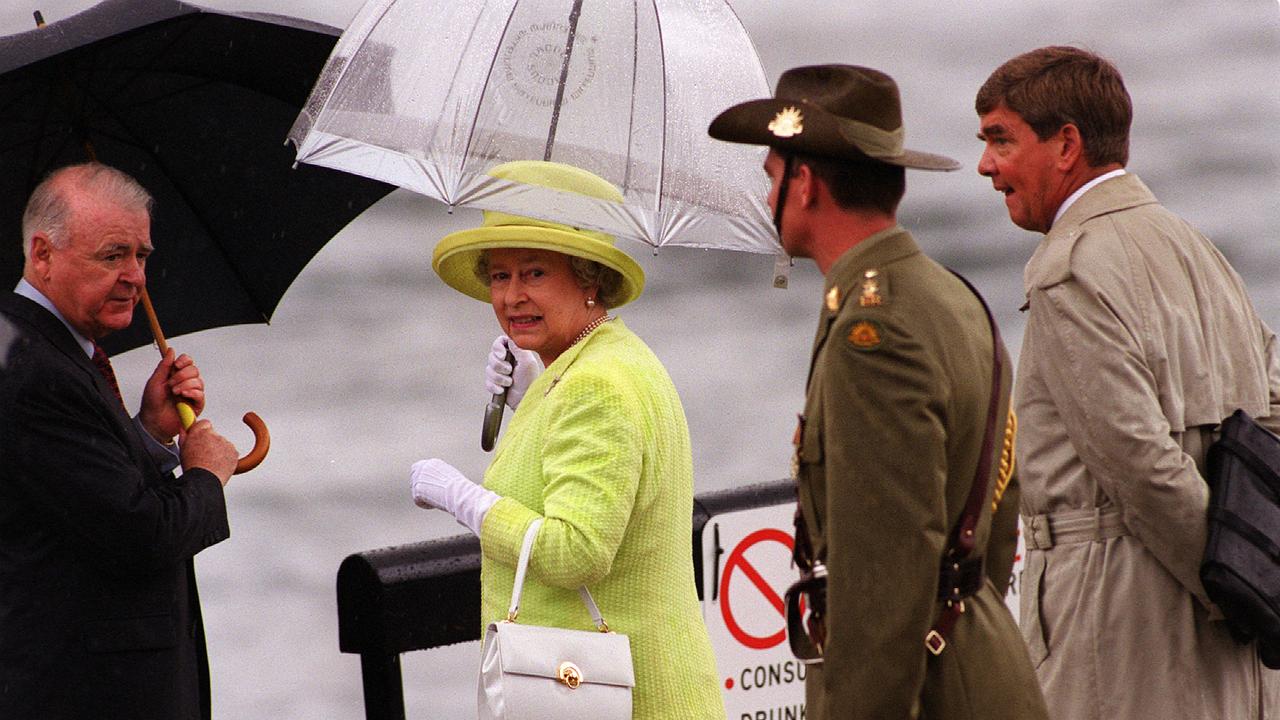 MARCH 20, 2000 : Queen Elizabeth II under an umbrella with Sir William Deane during her official welcome at Sydney Opera House.