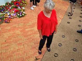 Judy Polzin places a plaque in Gayndah's memorial walkway to honour her father Oliver Perry who served in World War II. Picture: Felicity Ripper