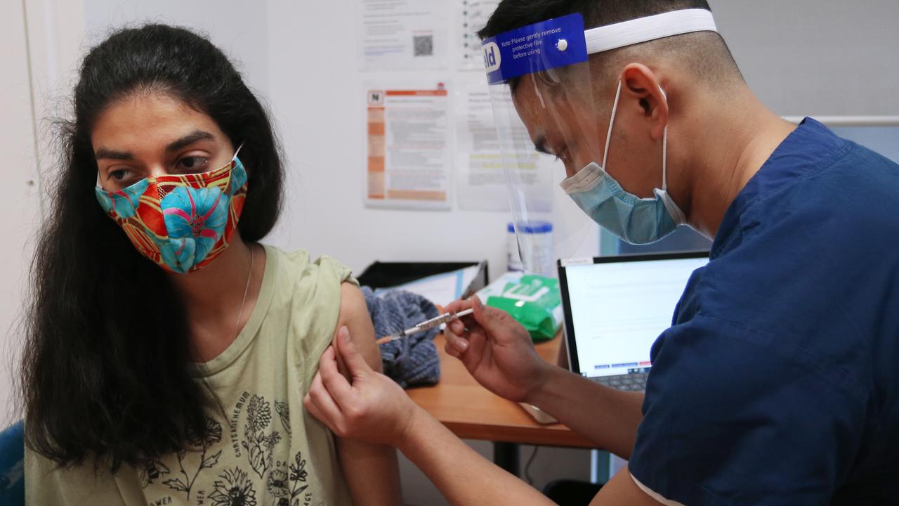 Nurse John Maya administers the Pfizer vaccine to a client at the St Vincent's Covid-19 Vaccination Clinic in Sydney. Picture: Lisa Maree Williams/Getty Images