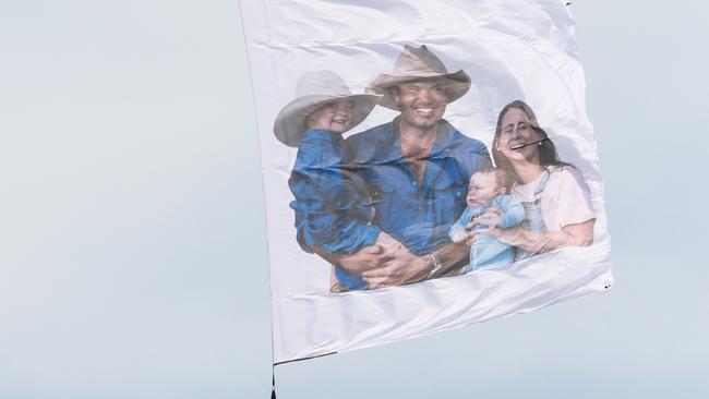 Skydivers brought down a giant flag bearing Mr Wilson’s family at his funeral in March. Picture: Glen Campbell