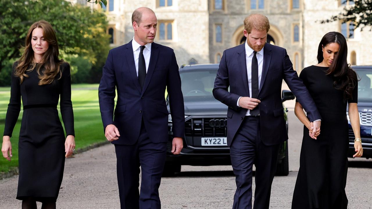 Polar opposites … Catherine and Meghan walk with their husbands. Picture: Getty