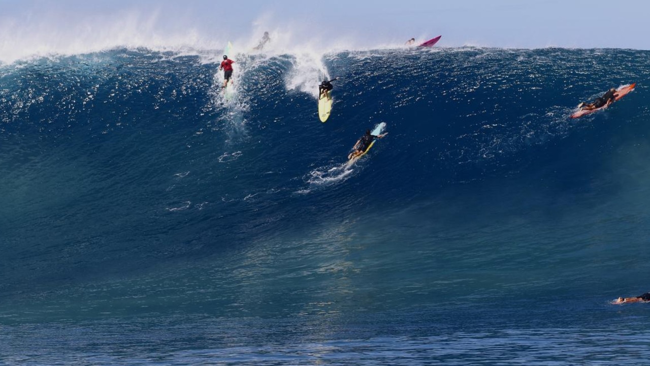 Australian surfer Laura Enever (on the yellow board) rides a 13.3m wave that landed her in the Guinness World Record books.