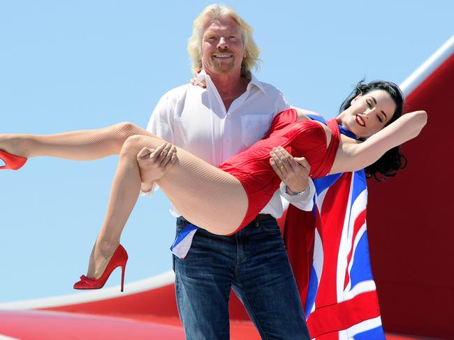 LAS VEGAS - JUNE 15:  Founder and President of Virgin Group Sir Richard Branson holds burlesque artist Dita Von Teese as they appear on the wing of a Virgin Atlantic Airways 747-400 aircraft at McCarran International Airport June 15, 2010 in Las Vegas, Nevada. Branson is celebrating his British airline's 10th anniversary of flying between London and Las Vegas.  (Photo by Ethan Miller/Getty Images)