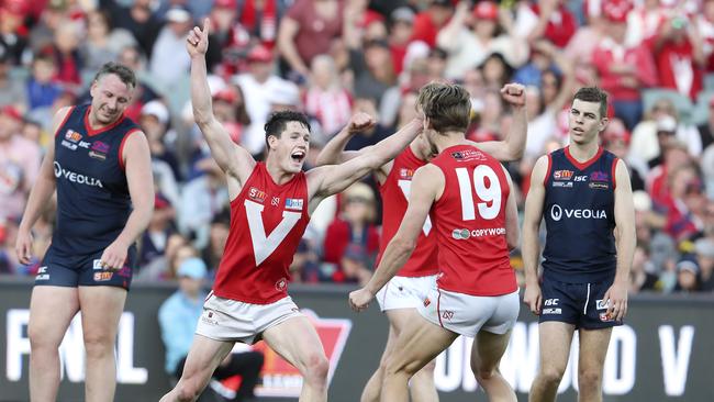 Samuel McInerney celebrates his goal with Lewis Hender in the fourth quarter to seal North Adelaide’s grand final win against Norwood. Picture SARAH REED