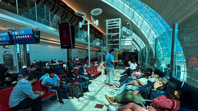 Passengers wait for their flights at the Dubai International Airport in Dubai on April 17, 2024. Dubai's major international airport diverted scores of incoming flights on April 16 as heavy rains lashed the United Arab Emirates, causing widespread flooding around the desert country.