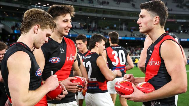 Ben Hobbs, Nic Martin and Archie Perkins of the Bombers celebrate after the 2023 AFL Round 13 match between the Carlton Blues and the Essendon Bombers. (Photo by Dylan Burns/AFL Photos via Getty Images)