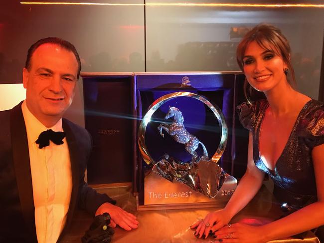 Racing NSW boss Peter V'Landys with Delta Goodrem and The Everest trophy in Los Angeles last year.