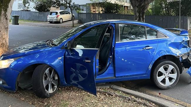 A blue sedan was smashed into a tree in Oriel Park, Clayfield. Police have arrested two men over the incident